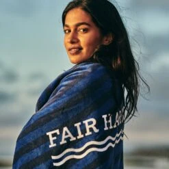The FH Organic Beach Towel | Navy Waves -Fair Harbor towel onmodel d88cfc96 8e65 4c40 b901 f5532bee0e97